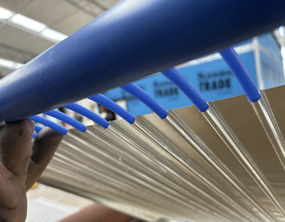 Underside view showing capillary tubes emerging from the omega-formed aluminium panel