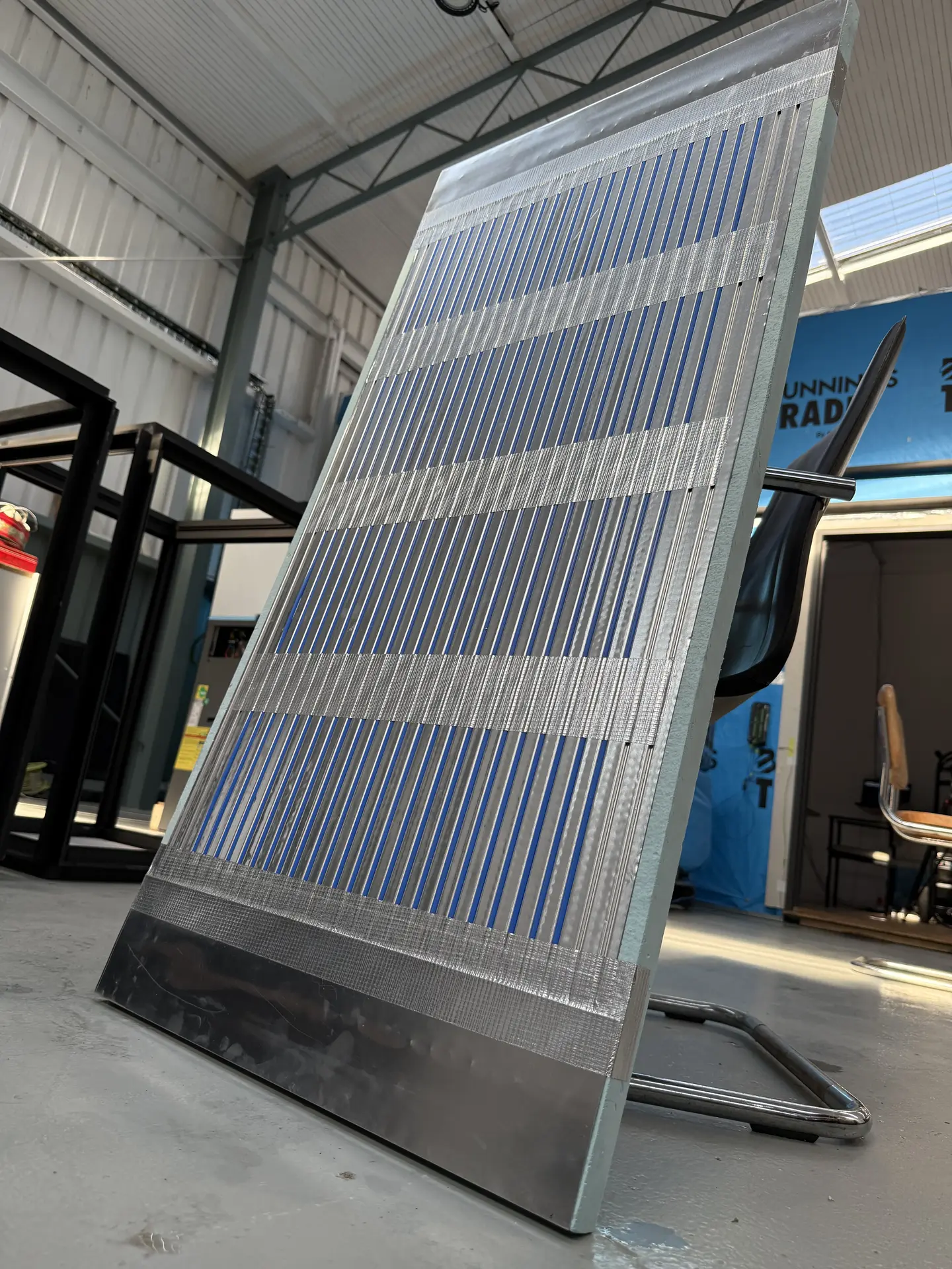 Panel standing upright showing the full capillary tube pattern and insulation backing