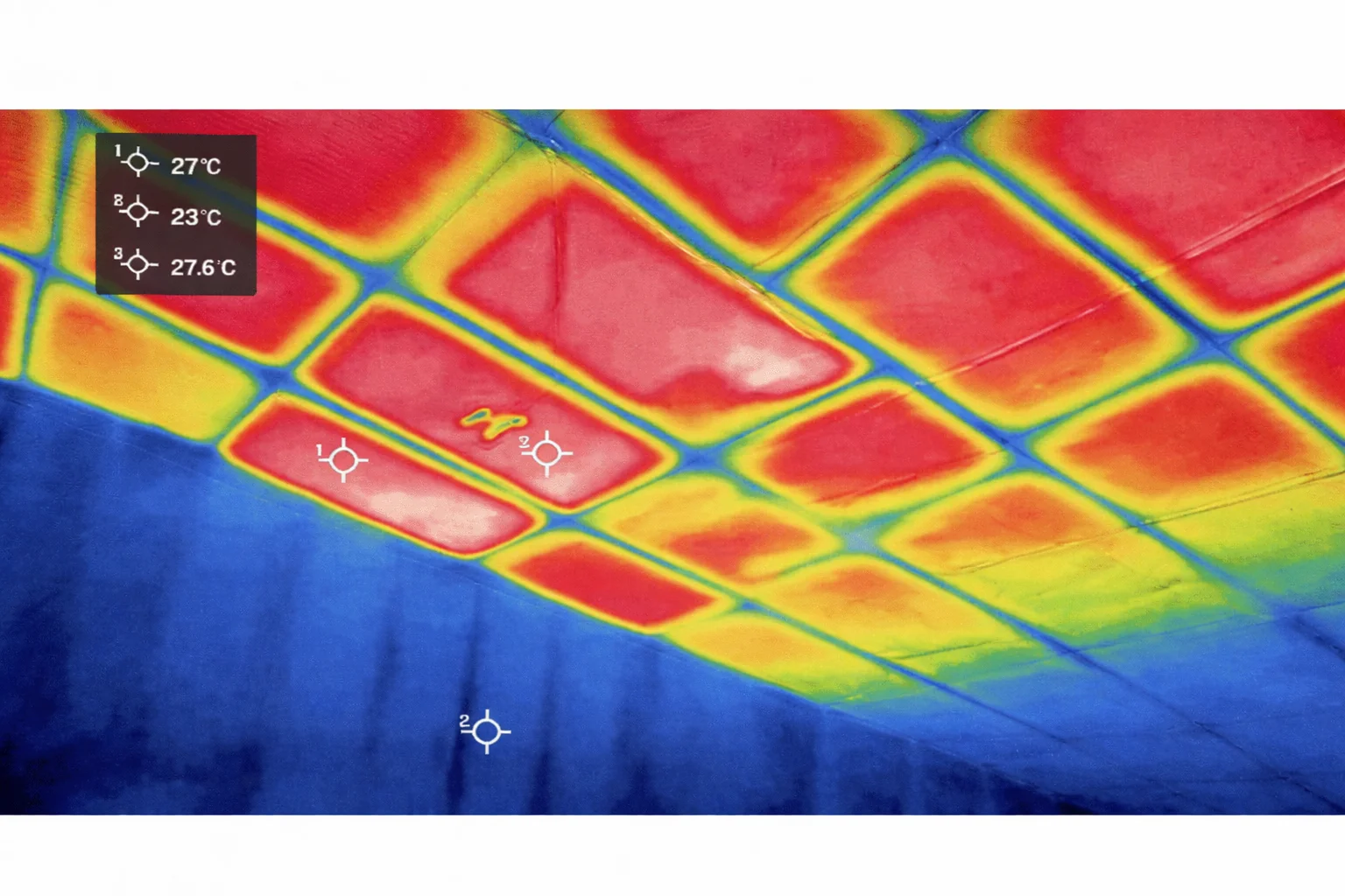 Thermal image of ceiling panels in heating mode showing uniform warm surface temperatures at 27.6°C in red and orange