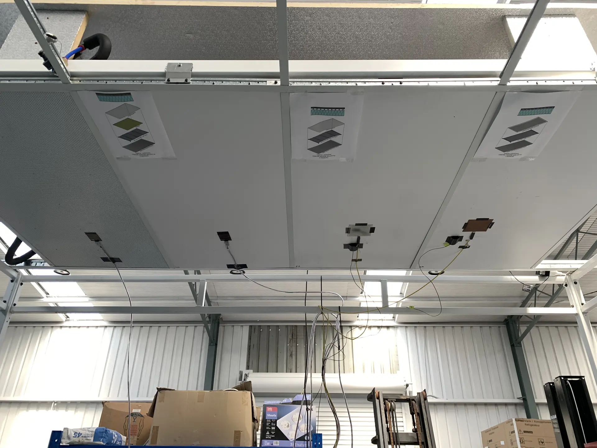 Finished ceiling inside the TestCell with panels installed and material samples displayed on the surface