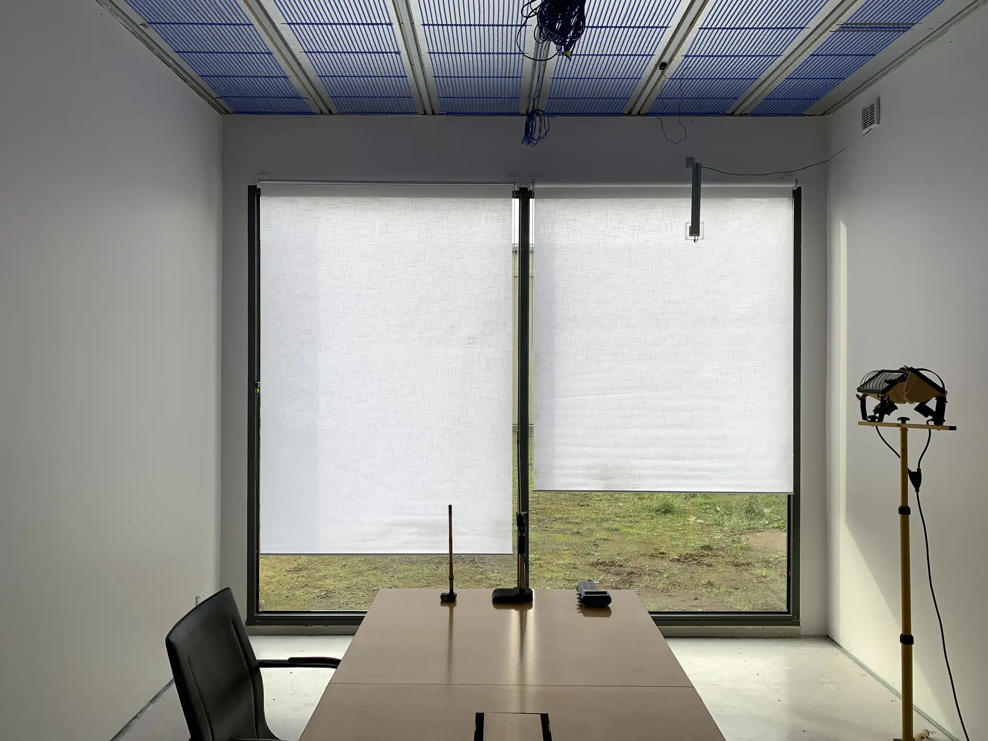 Interior view of the completed TESTCELL showing the double-glazed north window with blinds and instrumented workspace